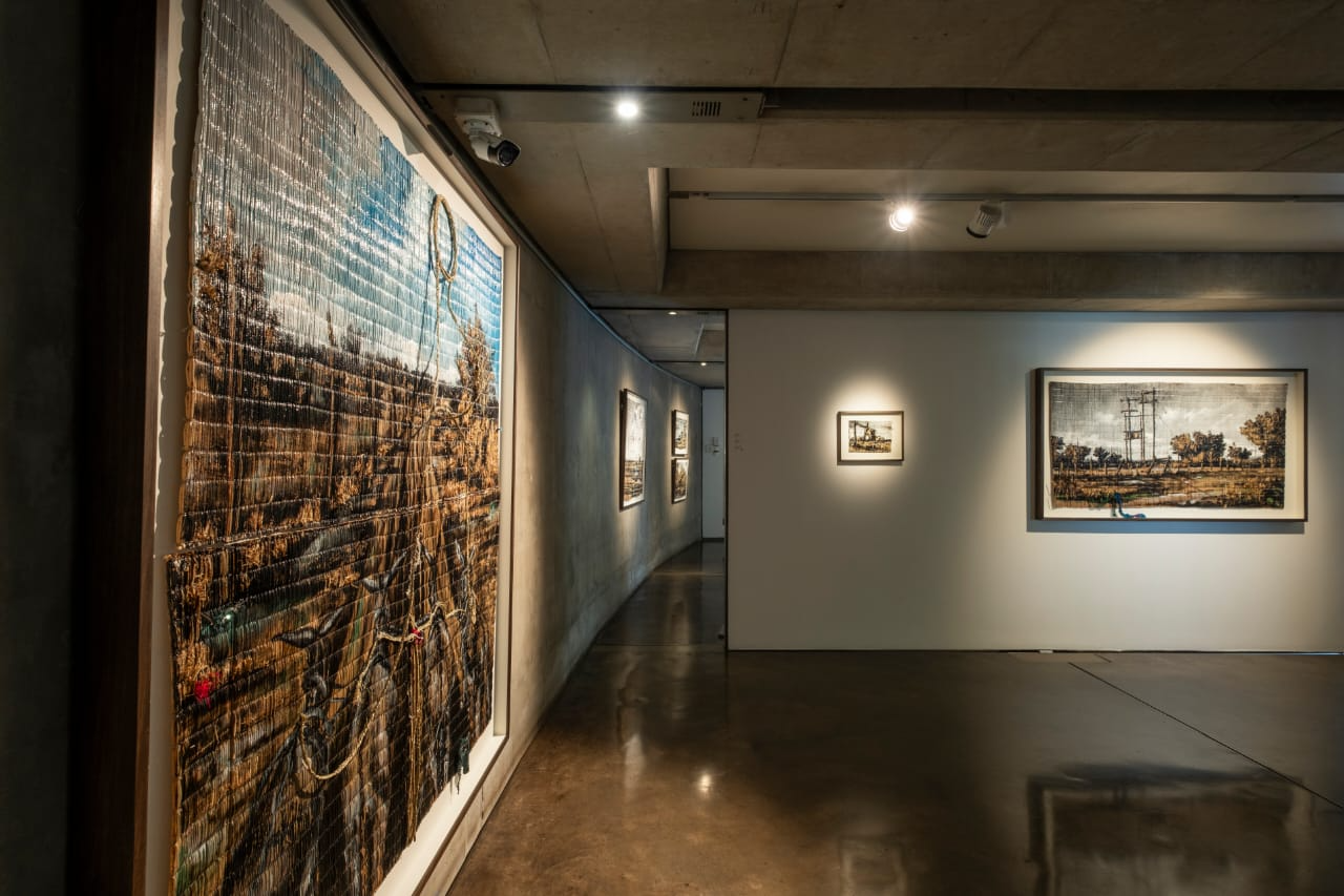 Detailed texture of charcoal, pastel, and acrylic painted on hand-woven Limpopo grass mat by Fumani Maluleke